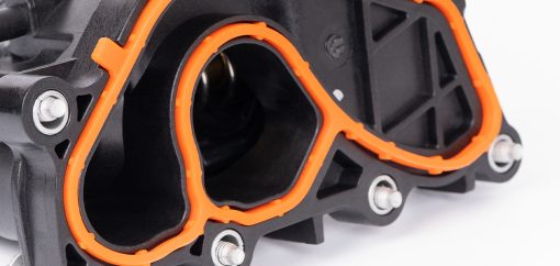 Overmolded and insert molded plastic part